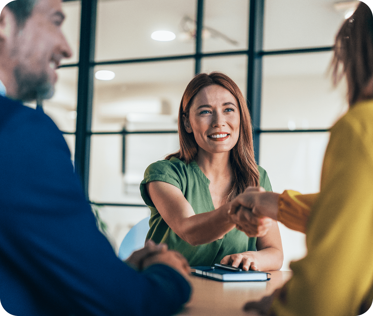 Professional woman shaking hands at office