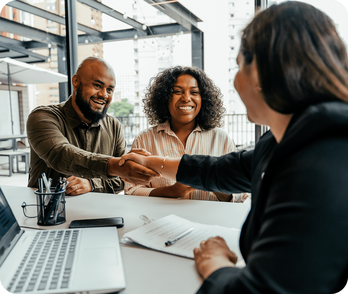 Business meeting handshake at desk